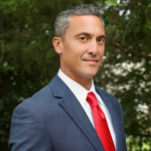 A man in a suit and red tie.